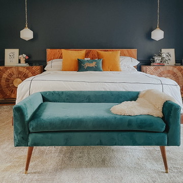 modern bedroom with navy wall and peacock blue bench