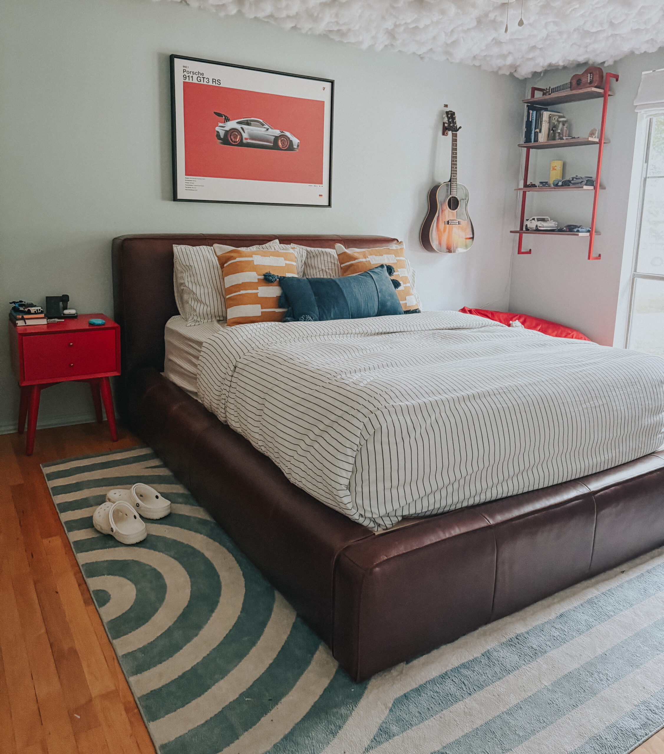 kelton, teen boy room, light blue walls, cloud ceiling, clouds, teenager, leather bed, porsche, car room, guitar, red nightstand