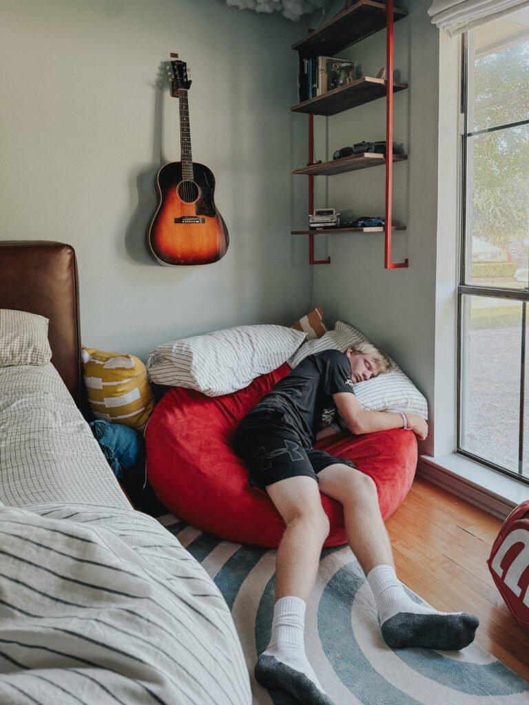 teen on bean bag chair asleep