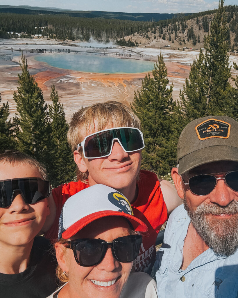 Family at the Grand Prismatic Spring in Yellowstone National Park on our Montana road trip