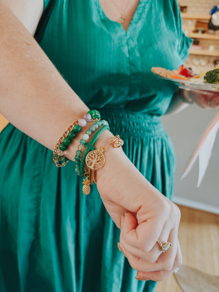 showing off her DIy charm bracelet