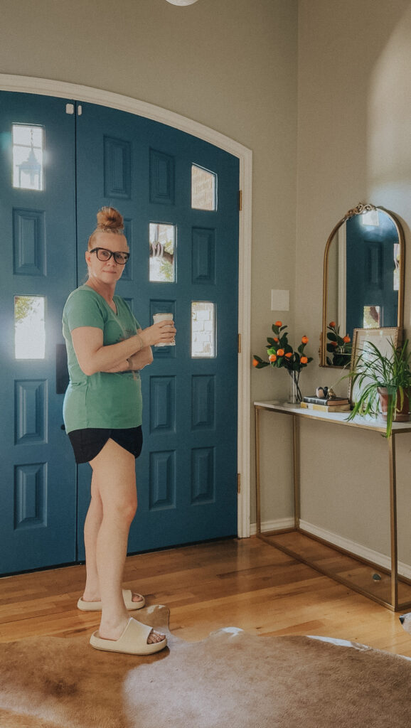 Standing in the original entryway before updating the space to better reflect our family's style