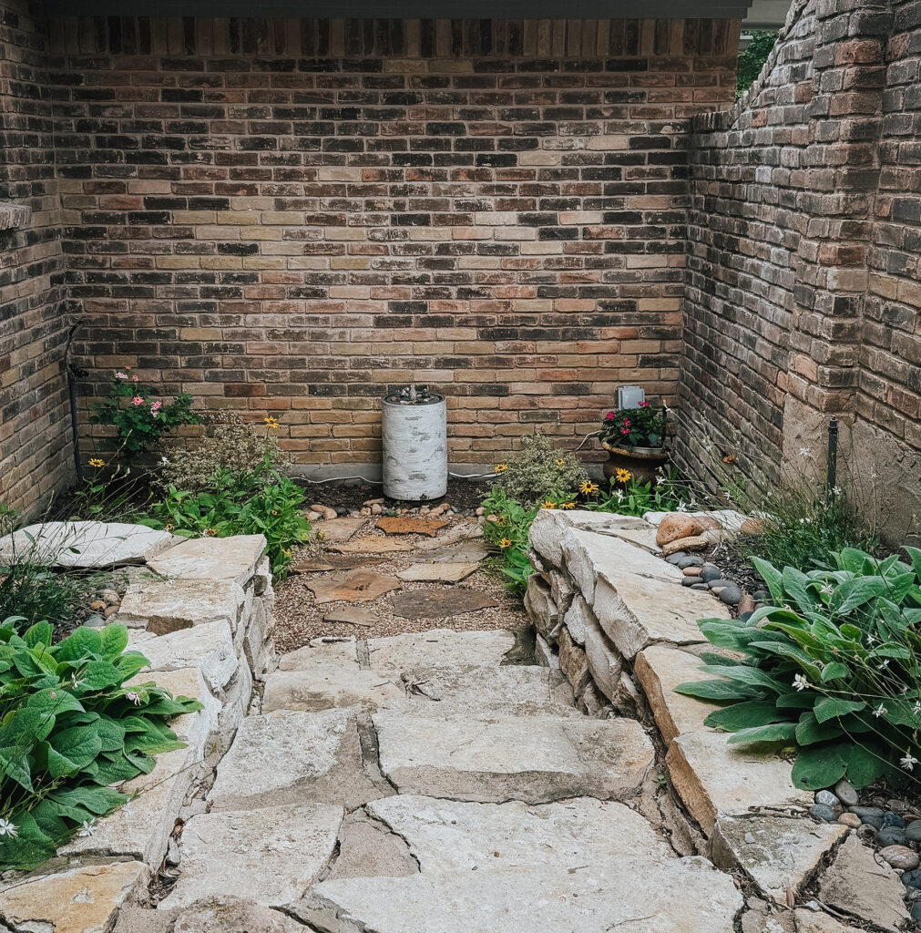 English cottage-inspired courtyard garden designed to feel relaxed, whimsical, and welcoming